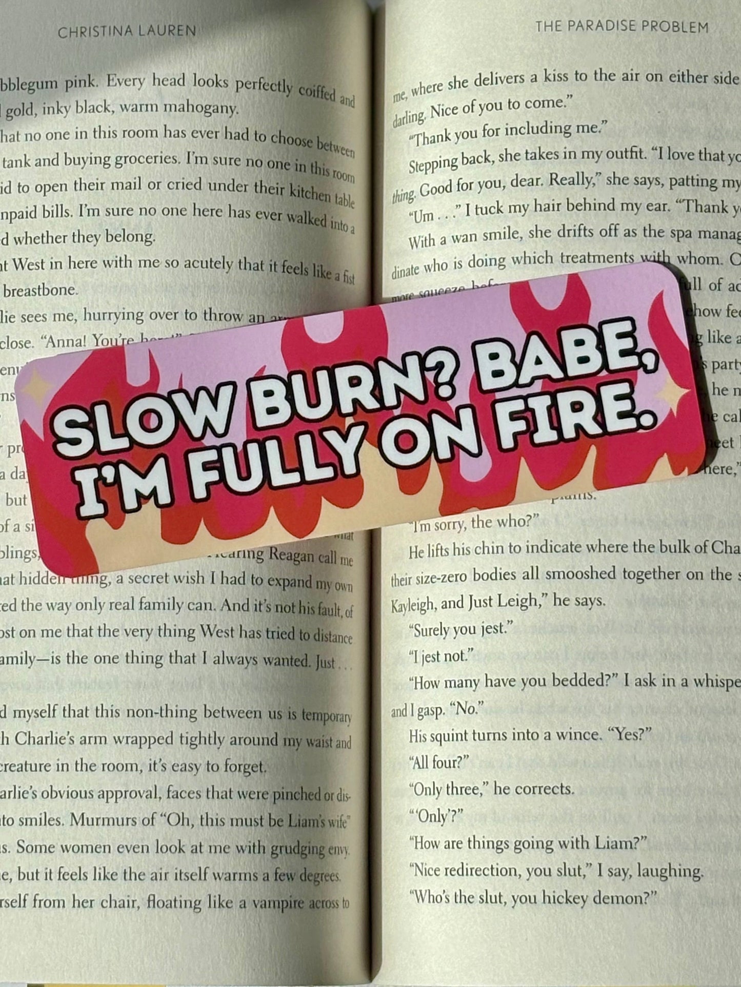 Bookmark with text 'SLOW BURN? BABE, I'M FULLY ON FIRE.' on an open book