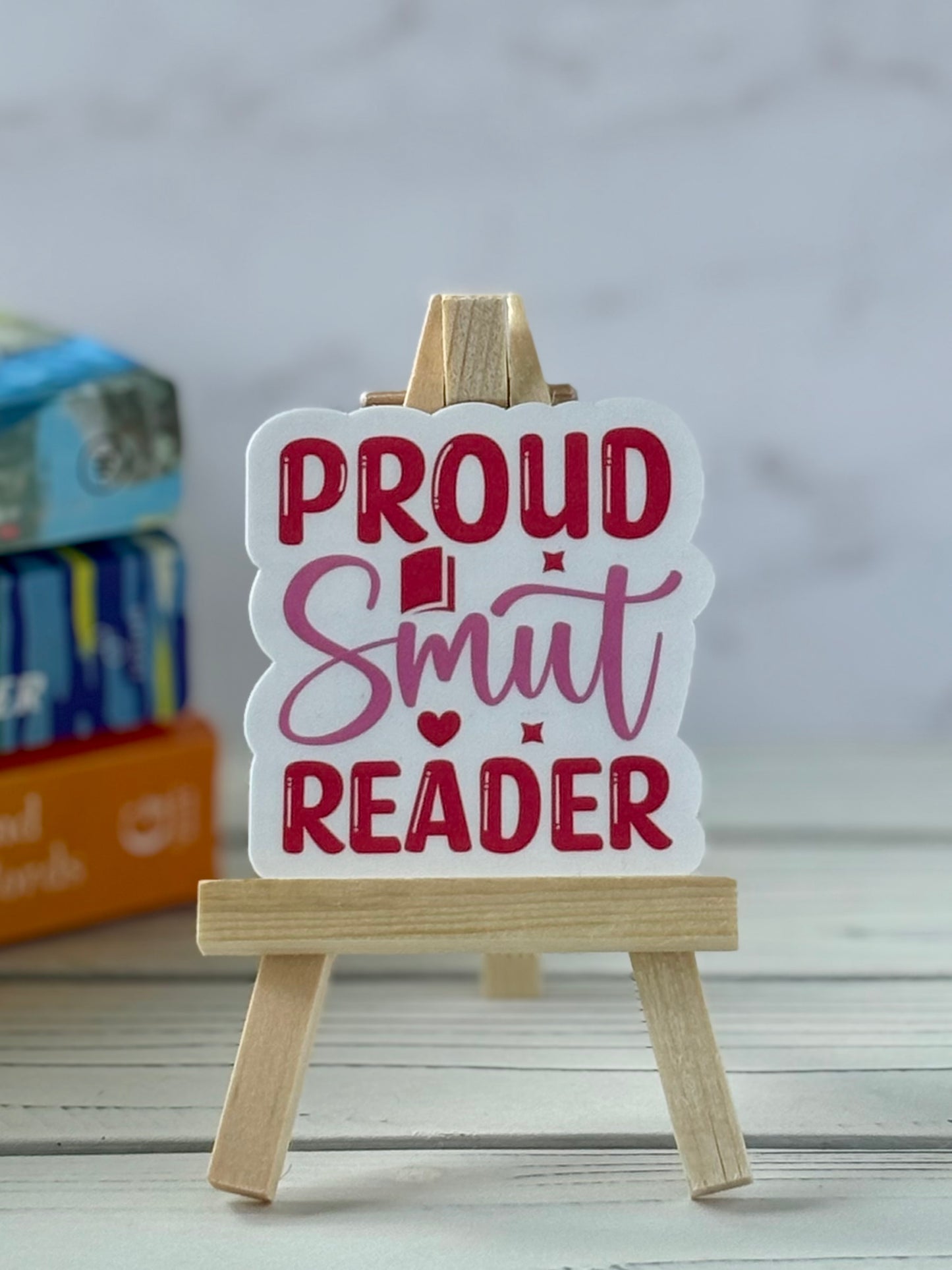 Sticker reading “Proud Smut Reader” in bold pink and red retro typography