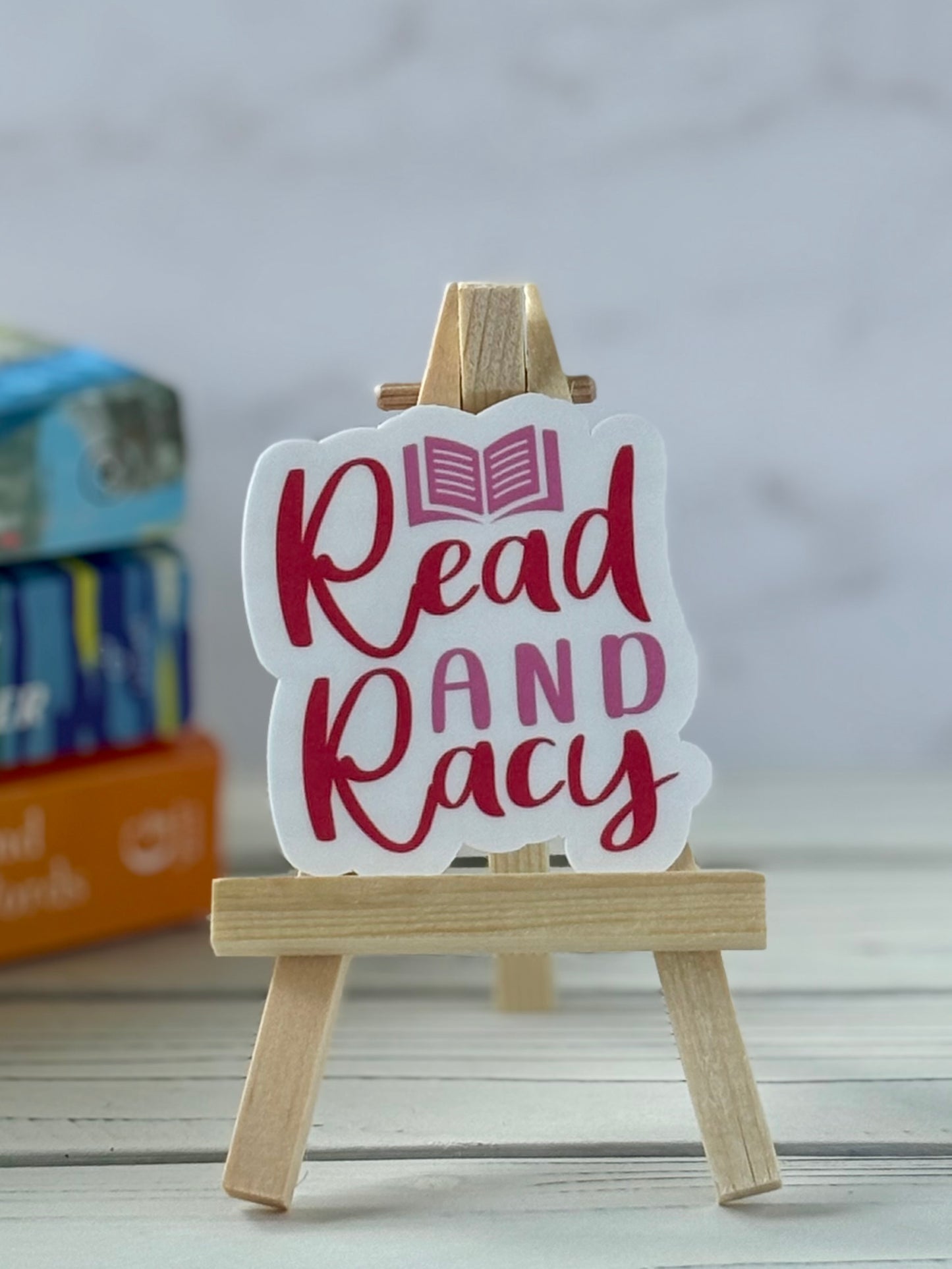 Pink and red retro text sticker that says “Read and Racy”