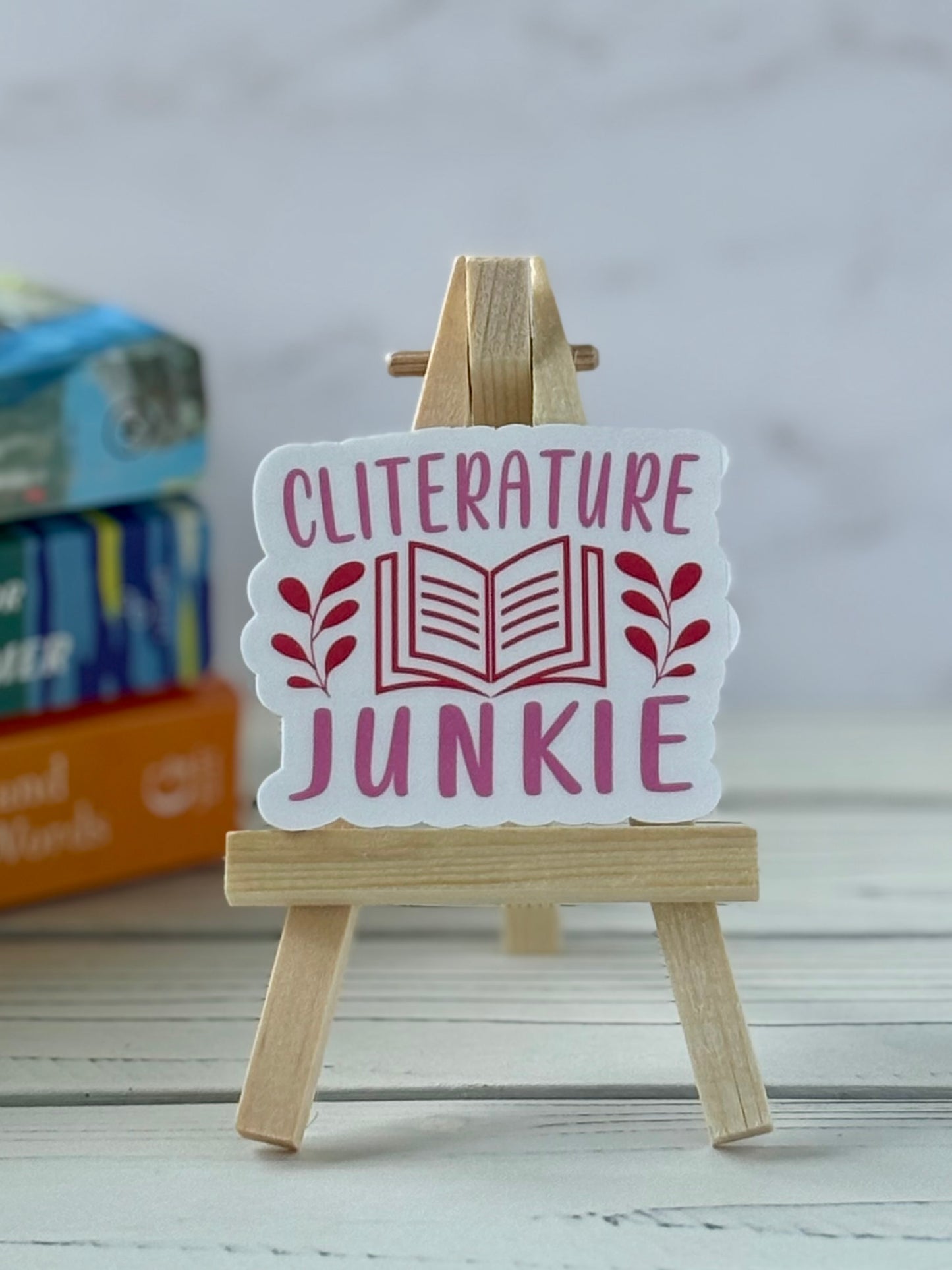 Pink and red retro text sticker reading “Cliterature Junkie”
