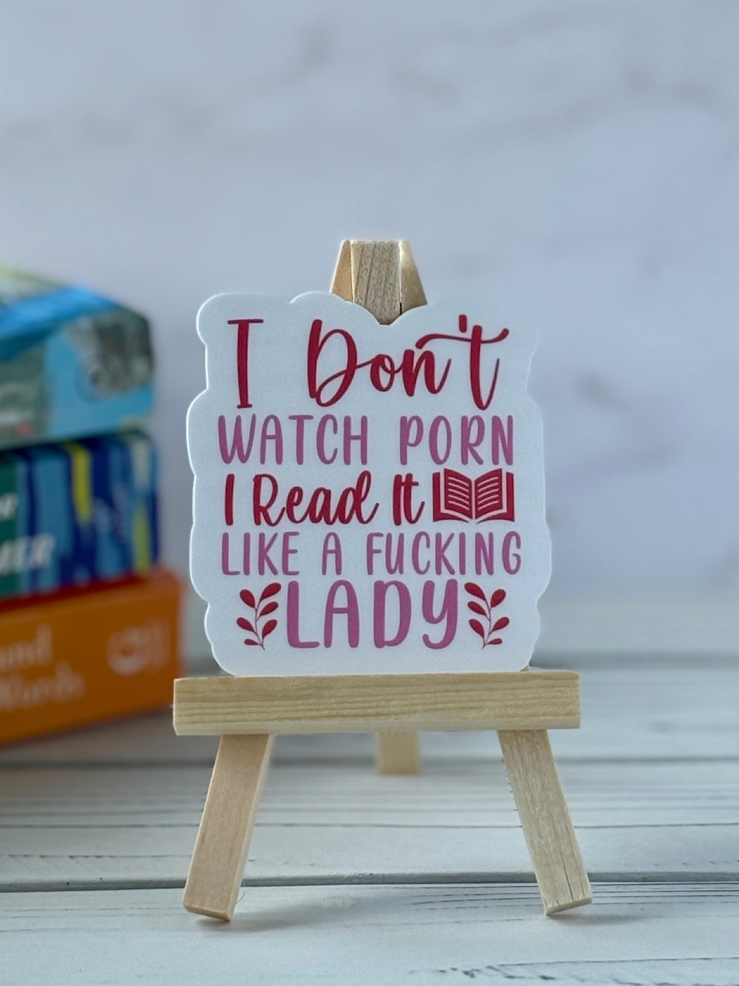 Sticker with pink and red retro text saying “I Don’t Watch Porn I Read It Like a fucking Lady.”