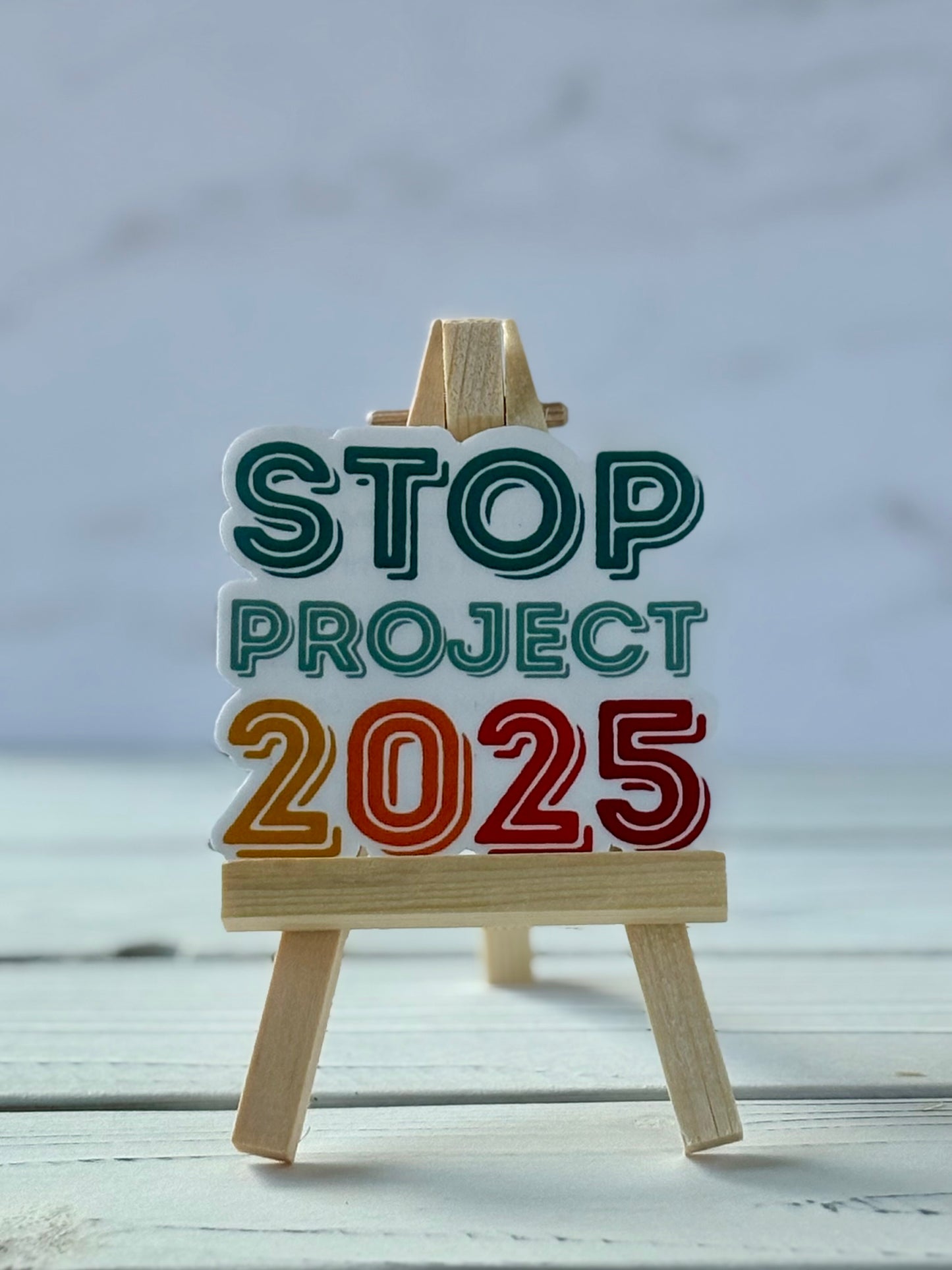 Stop Project 2025 protest sticker in bold typography, jewel-tone colors, Snark for Social Change collection.