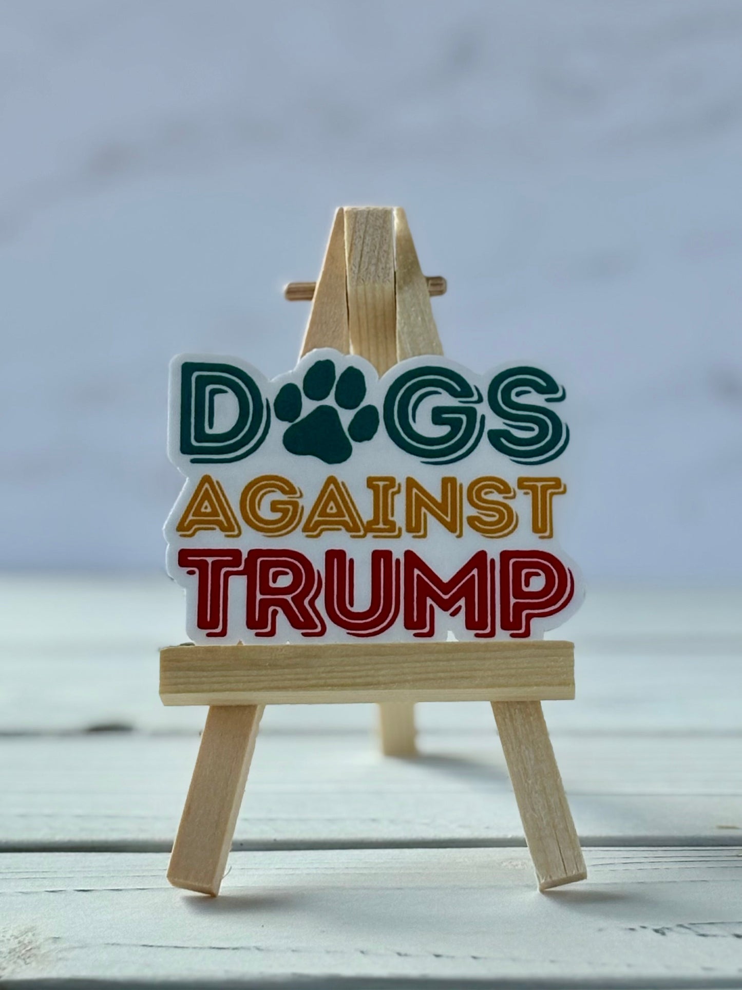 Dogs Against Trump protest sticker in bold typography, jewel-tone colors, Snark for Social Change collection.