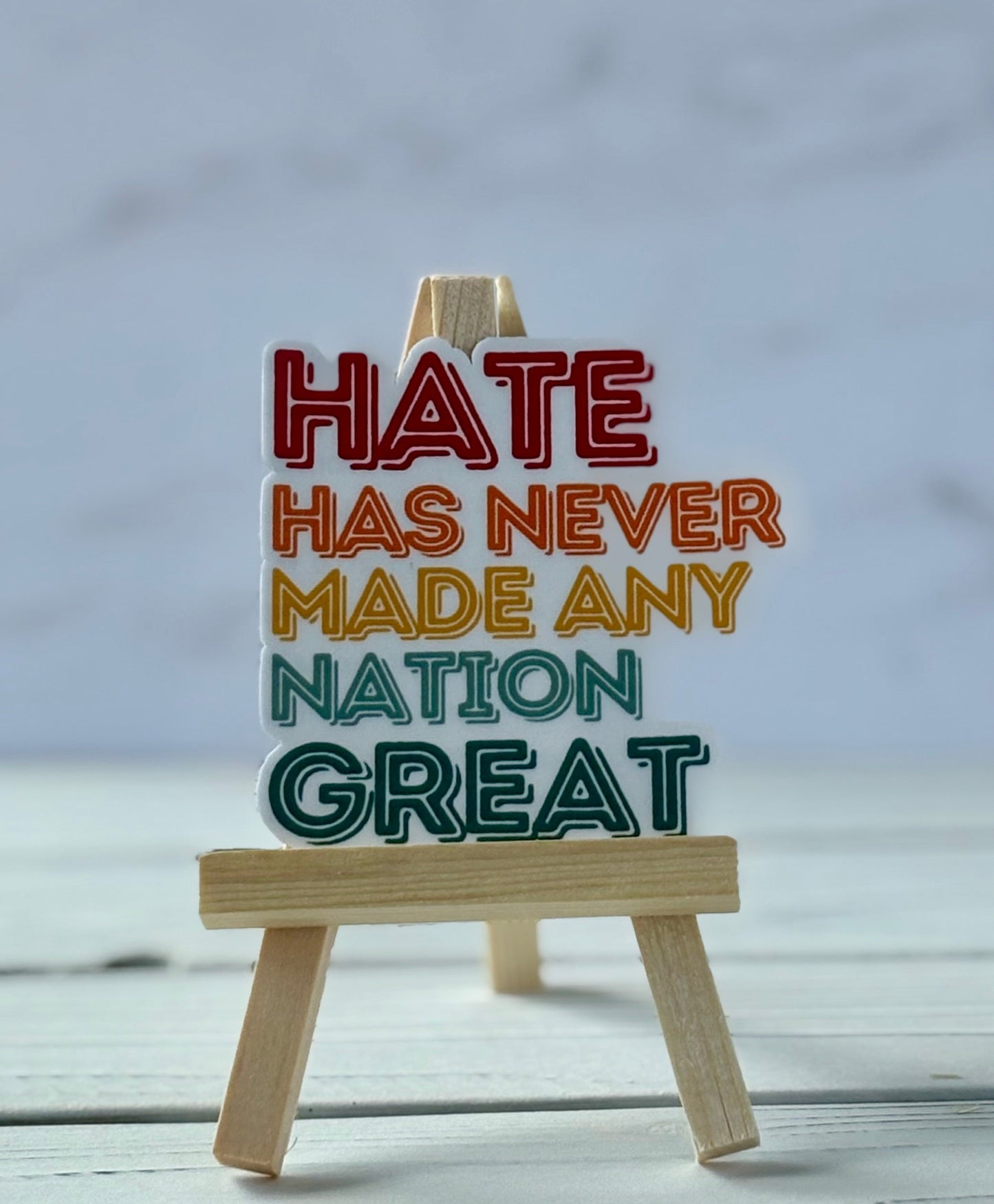 Hate Has Never Made Any Nation Great protest sticker in bold typography, jewel-tone colors, Snark for Social Change collection.