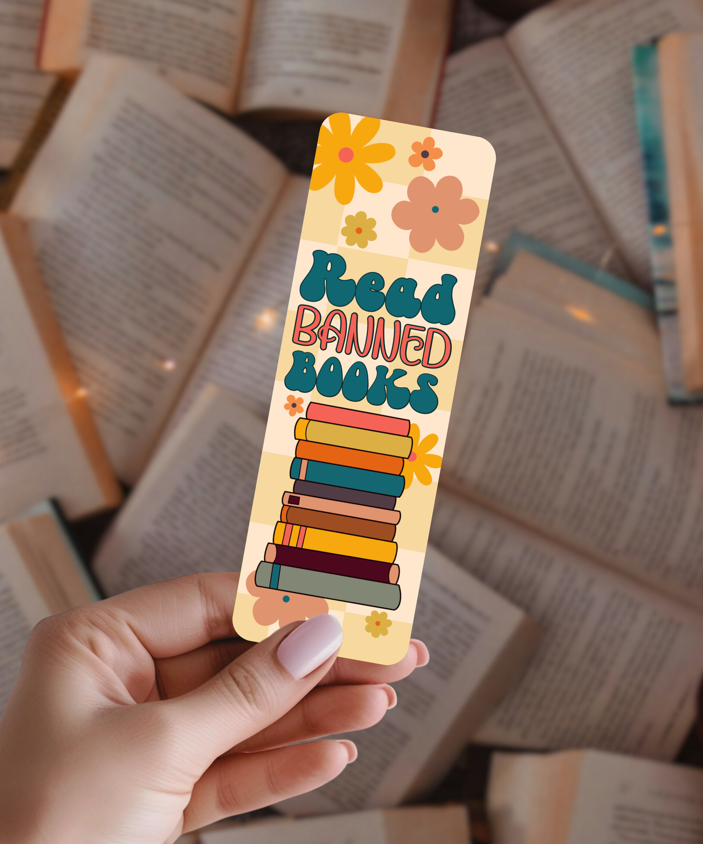 Colorful bookmark with 'Read Banned Books' text held over open books