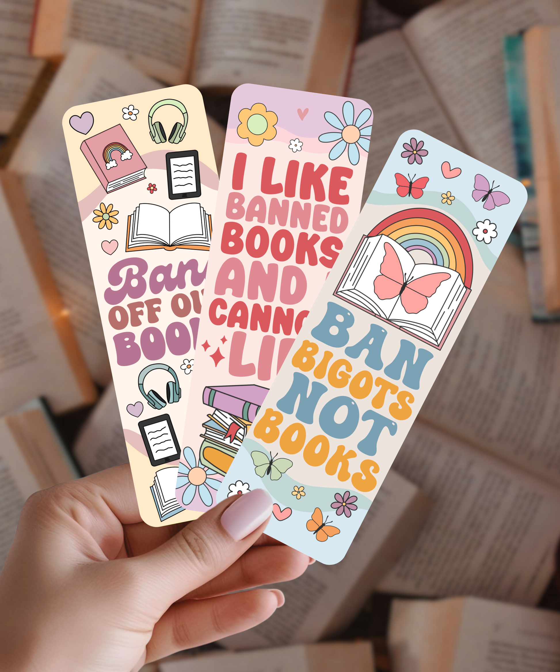 Colorful banned books bookmarks held by a hand with books in the background