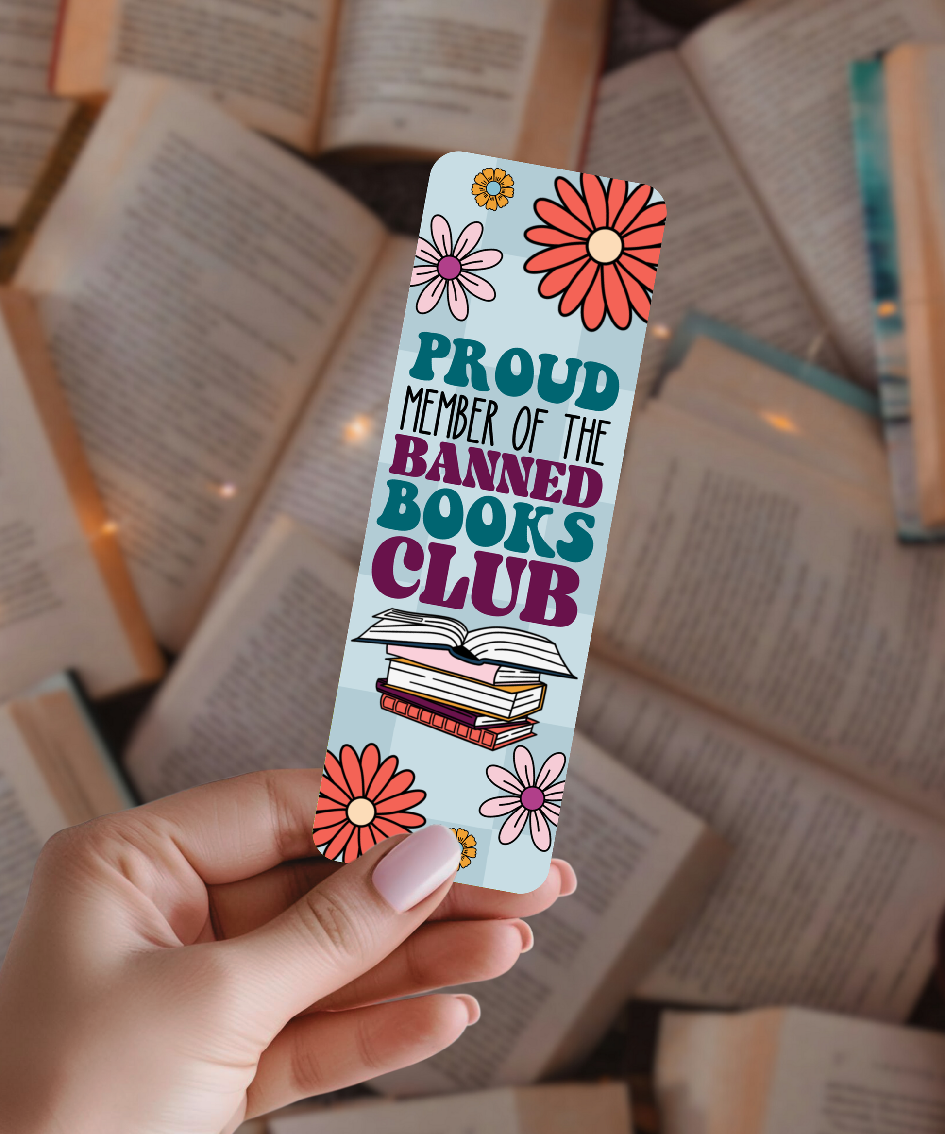 Colorful bookmark with 'Proud Member of the Banned Books Club' text held over open books