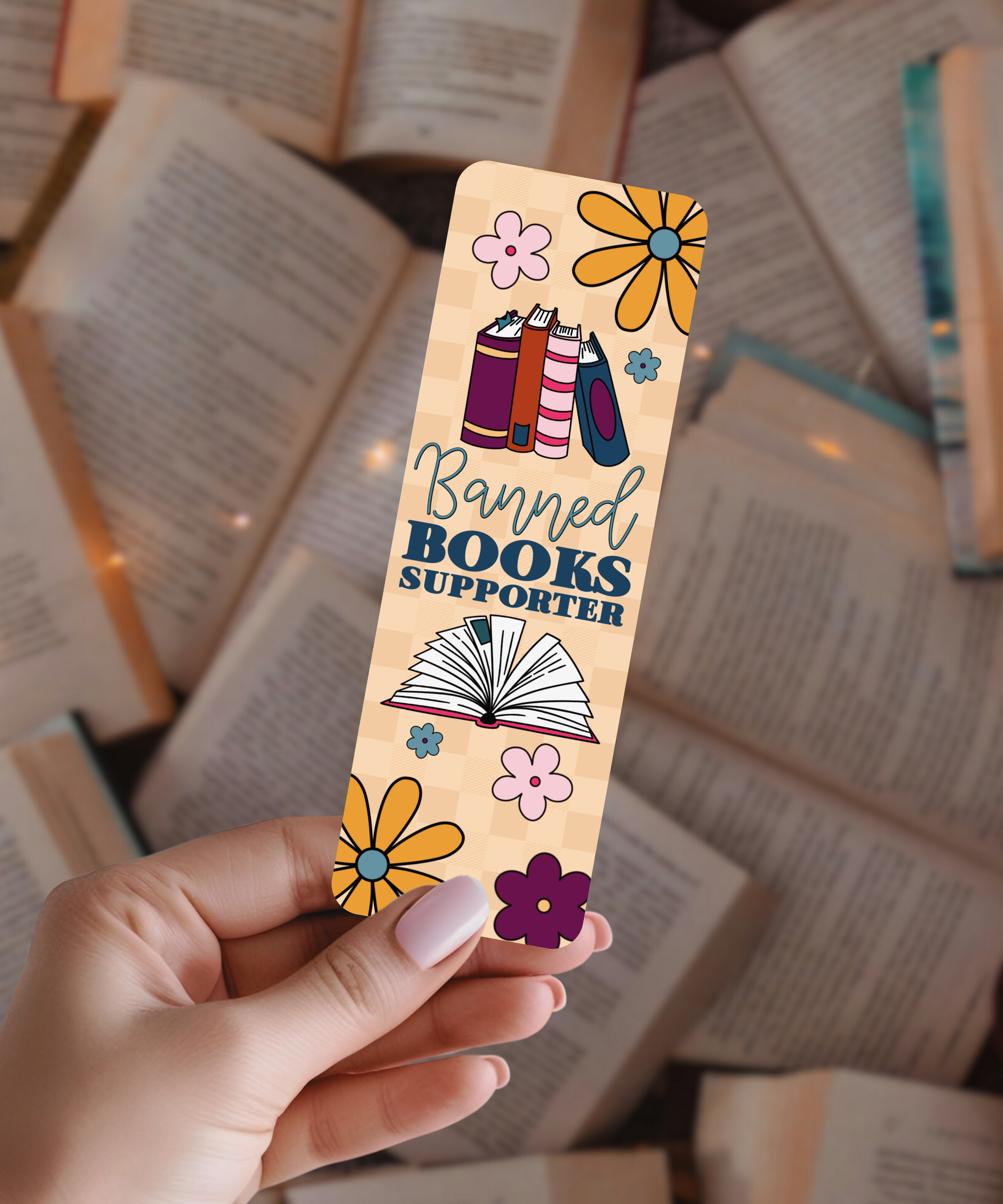 Colorful bookmark with 'Banned Books Supporter' text held over open books