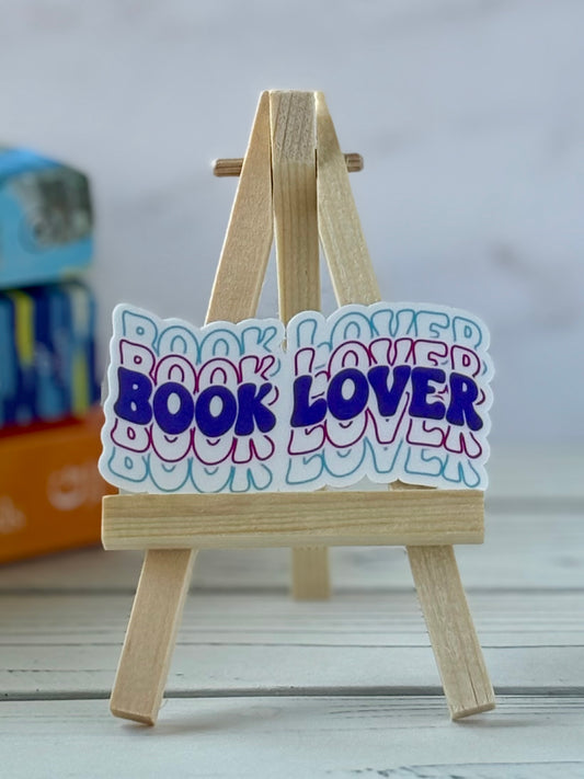 Wooden easel with 'Book Lover' retro vinyl sticker on a light background