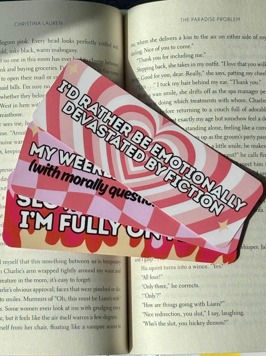 Three bookmarks fanned out on an open book.
