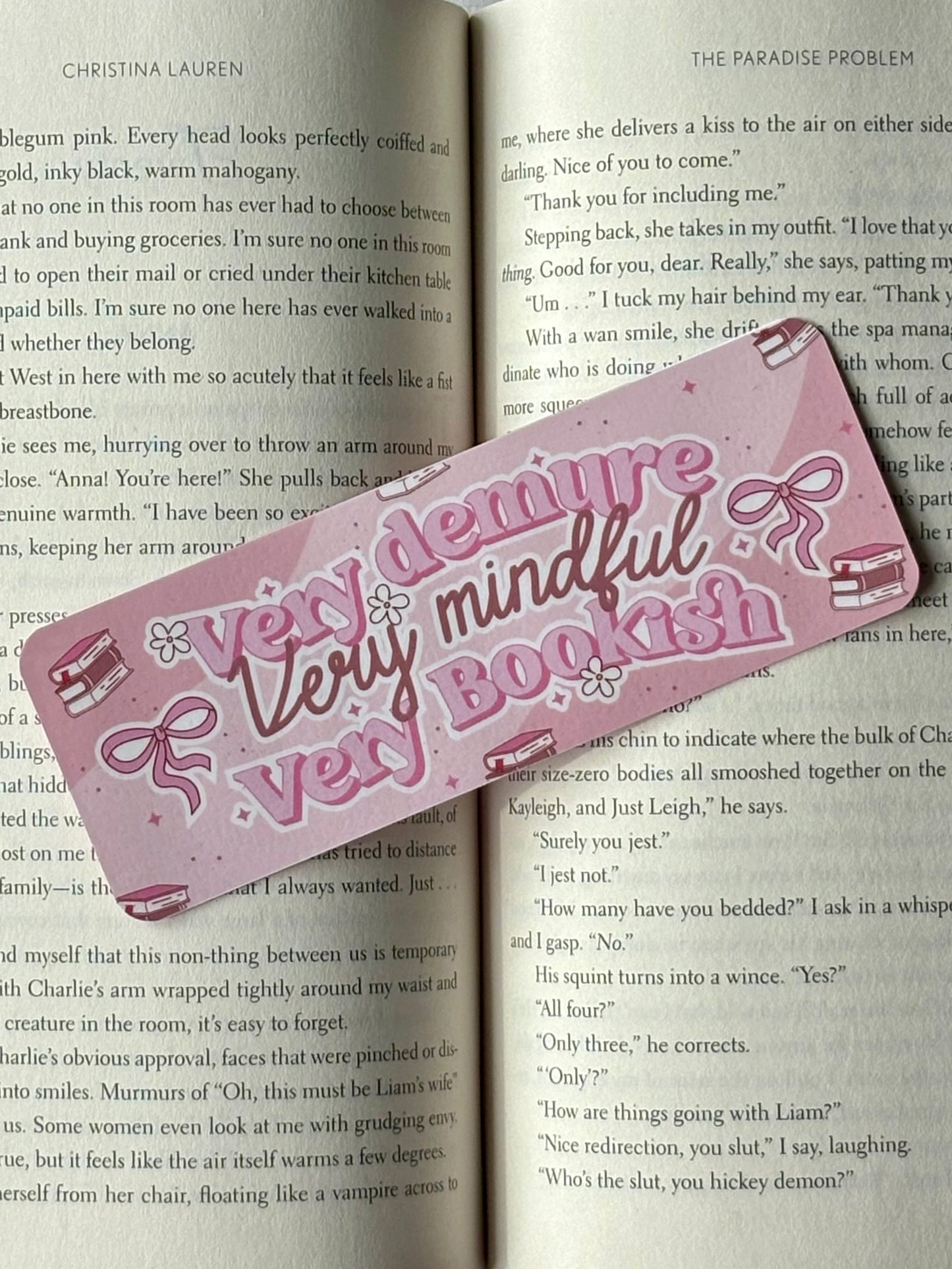 Pink bookmark with decorative text on an open book