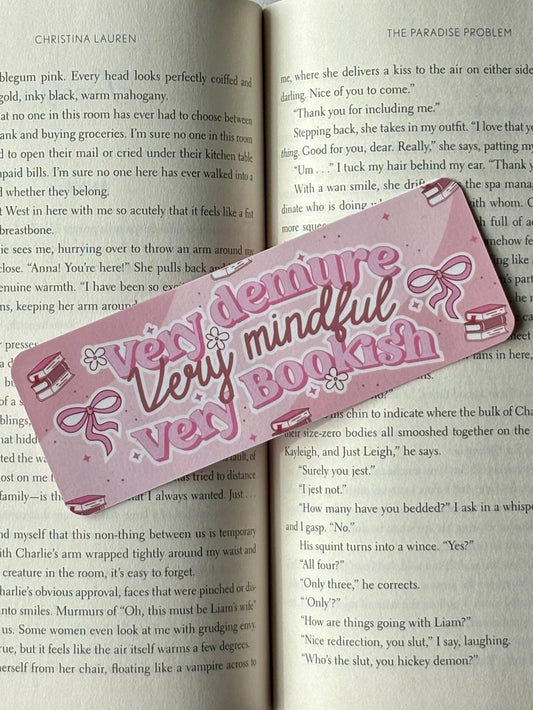 Pink bookmark with decorative text on an open book