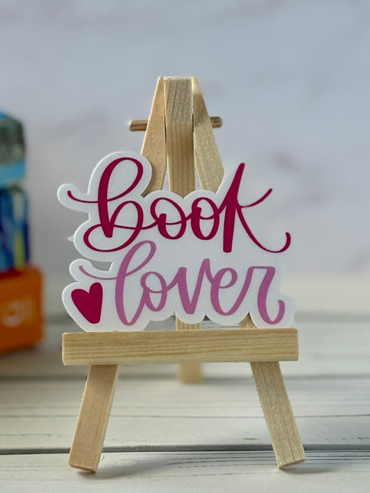 Wooden stand with 'Book Lover' sticker on a white background