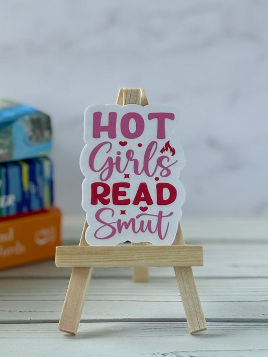 Sticker with retro pink and red text saying “Hot Girls Read Smut”