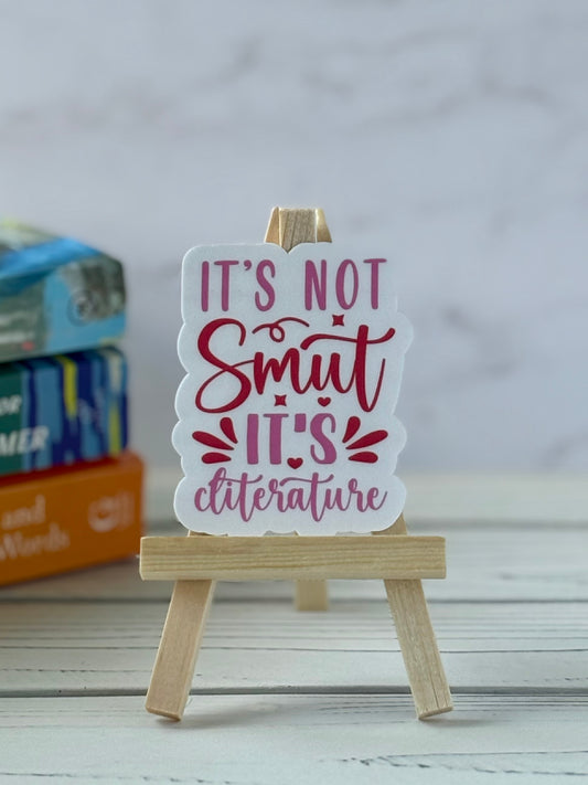 Pink and red retro sticker saying “It’s Not Smut It’s Cliterature”