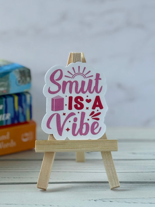 Sticker with retro pink and red text saying “Smut Is a Vibe.”