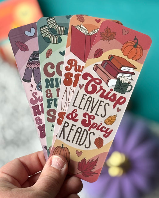 Spicy fall-themed bookmarks with deep autumn colors, pumpkins, and cozy romance book quotes