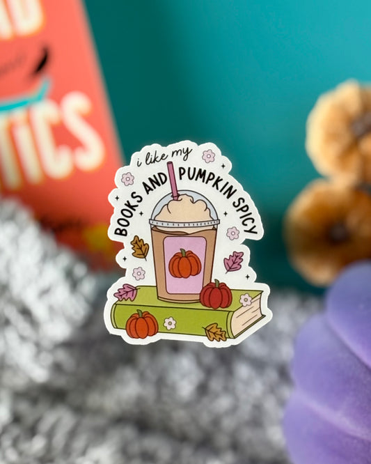Sticker with pumpkin spice Frappuccino on green book, decorated with pumpkins and fall leaves, reading “I like my books and pumpkin spicy.”