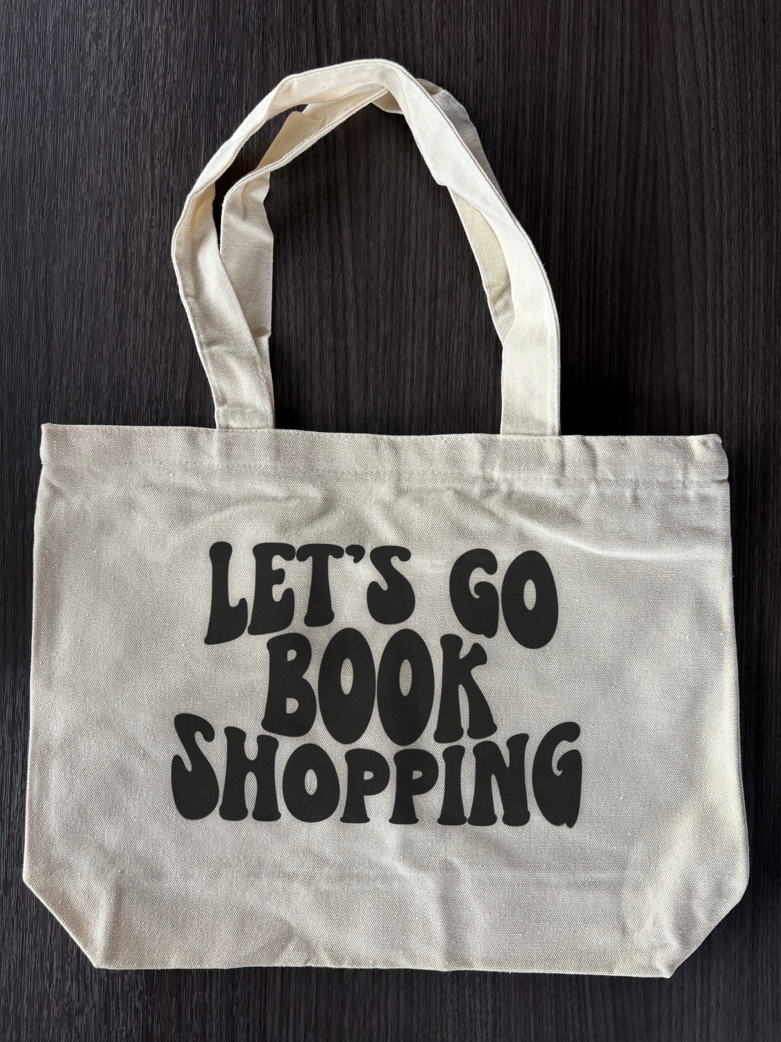Flat lay of Cute Bookish Tote Bag - Let's Go Book Shopping