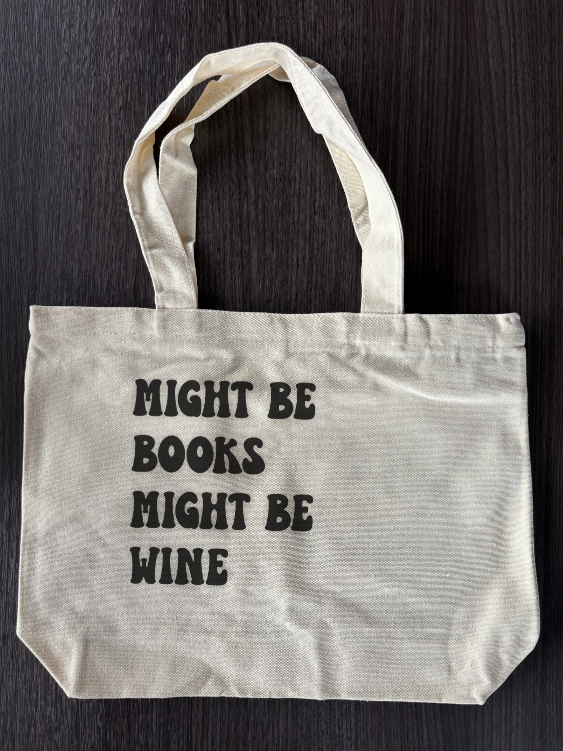 Flat lay of cute bookish tote bag Might Be Books Might Be Wine
