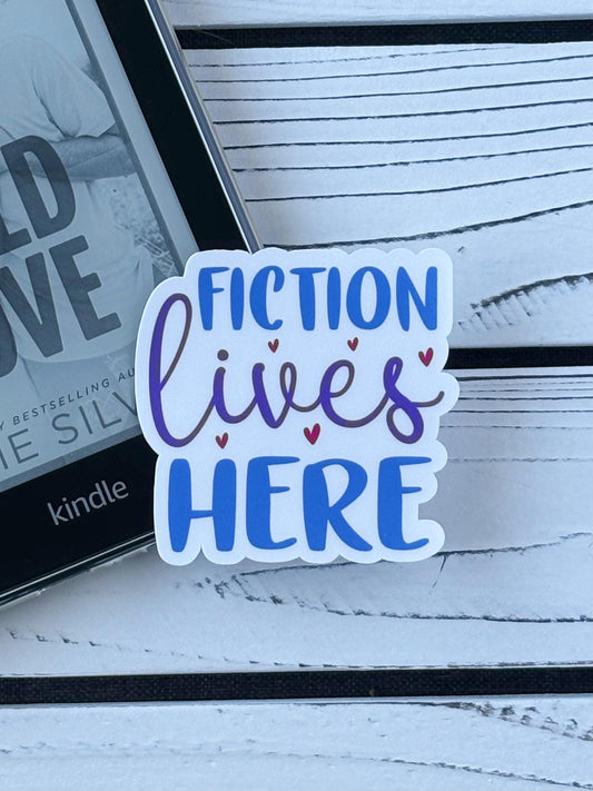 Sticker that says ‘Fiction Lives Here’ in bold retro lettering on a white background