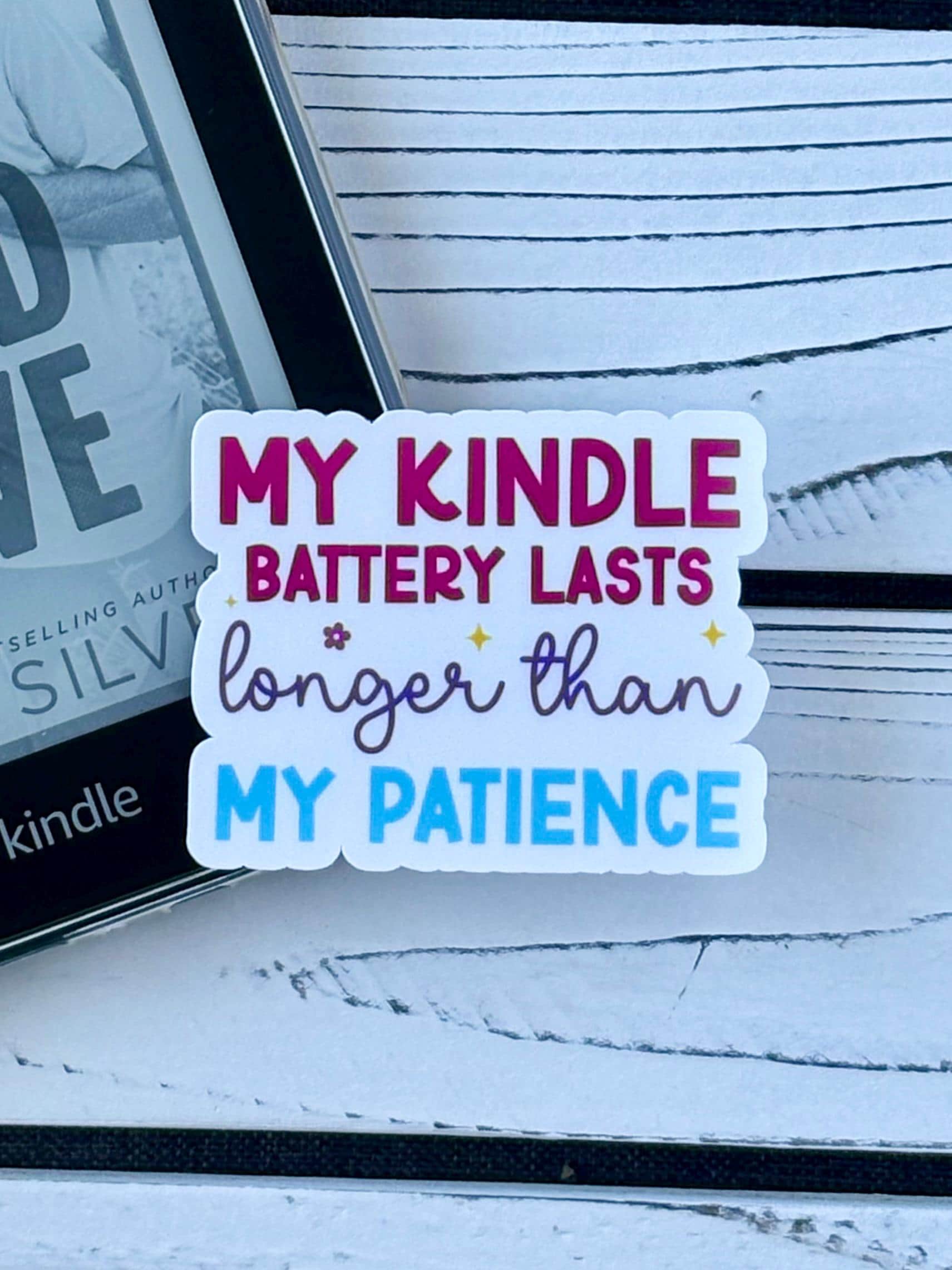 Sticker that says ‘My Kindle Battery Lasts Longer Than My Patience’ in colorful retro text on a white background